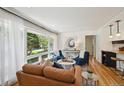 Bright living room featuring a large window, hardwood floors, and stylish furniture at 1370 S Hudson St, Denver, CO 80222