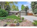 Charming single-story home boasts a well-manicured lawn, rock garden, mature trees, and a two-car garage at 5050 W 102 Ave, Westminster, CO 80031