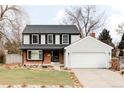 Charming two-story home with a well-manicured lawn and classic architectural details at 8856 W Prentice Ave, Littleton, CO 80123