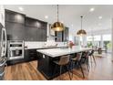 Contemporary kitchen features a large island, stainless steel appliances, and pendant lighting at 11383 Autumn Moon St, Littleton, CO 80125