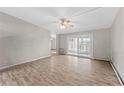 Bright living room with hardwood floors and sliding glass door at 595 S Alton Way # 5D, Denver, CO 80247