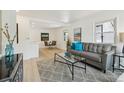 Bright living area with modern decor, light wood floors, and stylish furniture arrangement and ample natural light at 2120 Oak Pl, Thornton, CO 80229