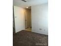 Neutral hallway leading to front door with neutral carpet at 2355 E Geddes Ave # G24, Centennial, CO 80122