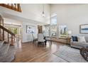 Open concept dining room and living room with large windows and hardwood floors at 8229 S Ogden Cir, Littleton, CO 80122