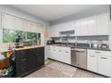 Kitchen featuring plenty of storage, stainless appliances, a black rolling island and a light-filled window view at 400 W Midway Blvd, Broomfield, CO 80020