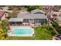 Aerial view showcasing a backyard with a pool, deck, outdoor seating, and well-maintained landscaping at 6474 W Canyon Ave, Littleton, CO 80128