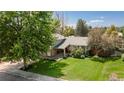 Aerial view of a home with a well-manicured lawn and mature trees offering ample shade and privacy at 6474 W Canyon Ave, Littleton, CO 80128