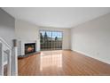 Bright living room with hardwood floors and a fireplace at 1818 S Quebec Way # 7-8, Denver, CO 80231