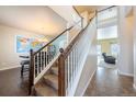 Elegant wooden staircase with carpeted steps and a view of the living room at 9021 Sandpiper Dr, Frederick, CO 80504