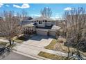Two-story home features an attached three-car garage and neutral-colored siding at 16240 E 119Th Ave, Commerce City, CO 80022