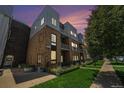 Beautiful exterior of a multi-story townhome with a brick facade and metal roof at sunset at 2530 Lawrence St # Ra301, Denver, CO 80205