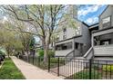 Inviting townhouse with a neat front yard and a classic gray exterior at 2 Acoma St # 11, Denver, CO 80223