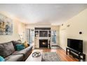 Cozy living room with a fireplace, wood floors, and a comfortable gray sofa at 2 Acoma St # 11, Denver, CO 80223