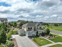 Beautiful home with a large driveway and well-manicured front yard at 23451 E Rockinghorse Pkwy, Aurora, CO 80016