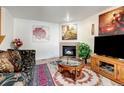 Cozy living room featuring a fireplace, warm decor, and comfortable seating, ideal for relaxation at 2213 Emery St # C, Longmont, CO 80501