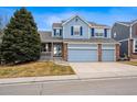 Charming two-story home with a three car garage, manicured lawn, and inviting curb appeal at 9928 Candlewood Ct, Highlands Ranch, CO 80126