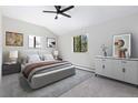 Cozy bedroom features a ceiling fan, neutral tones, and natural light at 8367 S Reed St # A3, Littleton, CO 80128