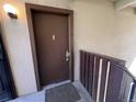 Brown front door with peephole and a combination lock at 9995 E Harvard Ave # 261, Denver, CO 80231