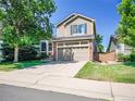Charming two-story home with a well-maintained lawn and a spacious driveway at 1234 Riddlewood Ln, Highlands Ranch, CO 80129