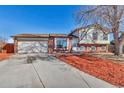 House exterior featuring a two-car garage and neat landscaping at 1912 S Truckee St, Aurora, CO 80013