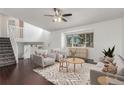 Bright living room with a ceiling fan, a view from the large window, and neutral decor at 5733 Whitechapel St, Castle Rock, CO 80104
