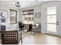 Cozy home office featuring a desk and chair by the window and stylish decor and light hardwood floors at 888 S Valentia St # 101, Denver, CO 80247
