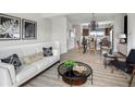 Well-lit living room featuring modern decor, a comfortable couch, and an open view of the kitchen at 888 S Valentia St # 101, Denver, CO 80247