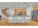 Kitchen island featuring granite countertops, pendant lighting, and stainless steel appliances at 5887 S Taft Ln, Littleton, CO 80127