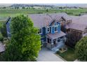 Aerial view of blue two-story home showcasing the roof, landscaping, and community views at 3216 Yale Dr, Broomfield, CO 80023