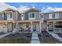 Attractive townhome showcasing stone accents, covered porch, and landscape design elements enhancing the overall curb appeal at 12205 Race St, Northglenn, CO 80241