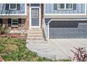 Close up of a home's front door and entrance, showcasing the architecture and design details of the exterior at 11225 W 102Nd Pl, Westminster, CO 80021