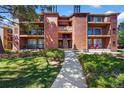 Well-maintained apartment building with brick accents and lush landscaping at 4899 S Dudley St # 19, Littleton, CO 80123