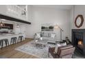 Open living space with a fireplace, kitchen bar, and loft above at 4899 S Dudley St # 19, Littleton, CO 80123