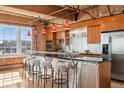 Contemporary kitchen island featuring stainless steel accents, modern stools, and updated appliances at 1616 14Th St # 4E, Denver, CO 80202