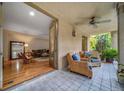 Relaxing covered patio featuring tile floors, inviting wicker chairs, and seamless indoor-outdoor flow to the living room at 581 Garfield St, Denver, CO 80206
