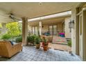 Charming covered patio with patterned tile flooring, comfortable seating, and access to the landscaped backyard at 581 Garfield St, Denver, CO 80206