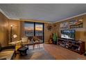 Inviting living room with comfortable chairs and a stunning sunset view from the balcony at 1301 Speer Blvd # 410, Denver, CO 80204