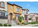 Eye-catching townhome featuring a stucco exterior, front patios, and well-manicured landscaping at 15592 W Wesley Ave, Lakewood, CO 80228