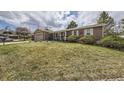 Beautiful brick single Gathering home with a lush green lawn, attached garage, and charming curb appeal at 6267 S Albion Ct, Centennial, CO 80121