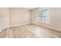 Bright bedroom featuring wood floors and a large arched window at 1648 S Cole St # A2, Lakewood, CO 80228