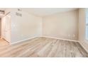 A spacious, empty bedroom with neutral walls, wood flooring, and a closet at 1648 S Cole St # A2, Lakewood, CO 80228