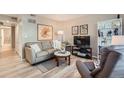 Comfortable living room featuring a sofa, entertainment center, and bright natural light at 1648 S Cole St # A2, Lakewood, CO 80228