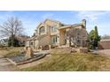 Stunning two-story home featuring manicured landscaping and a welcoming entrance at 5773 S Benton Way, Littleton, CO 80123