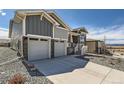 Attractive two-story home showcasing stone accents, two-car garage, and well-maintained landscaping at 651 Scrubjay Cir, Castle Rock, CO 80104