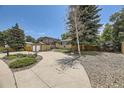 Two-story home with well-maintained landscaping including large trees and shrubbery at 2380 W 105Th Pl, Northglenn, CO 80234