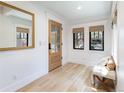 Bright entryway with wood floors, large mirror, and a cozy bench at 619 S Gilpin St, Denver, CO 80209