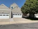 Inviting exterior view showcasing a two-story home with attached garage and meticulously maintained landscaping at 15555 E 40Th Ave # 11, Denver, CO 80239