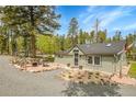 Cozy home with inviting outdoor space, perfect for relaxing by the fire and enjoying nature at 10887 Goodheart Ave, Conifer, CO 80433