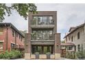 Modern brick townhouse boasts multiple balconies, creating inviting outdoor spaces at 1895 York St, Denver, CO 80206