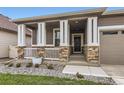 Inviting covered front porch featuring stone accents and a cozy entrance at 8953 Falcon St, Firestone, CO 80504